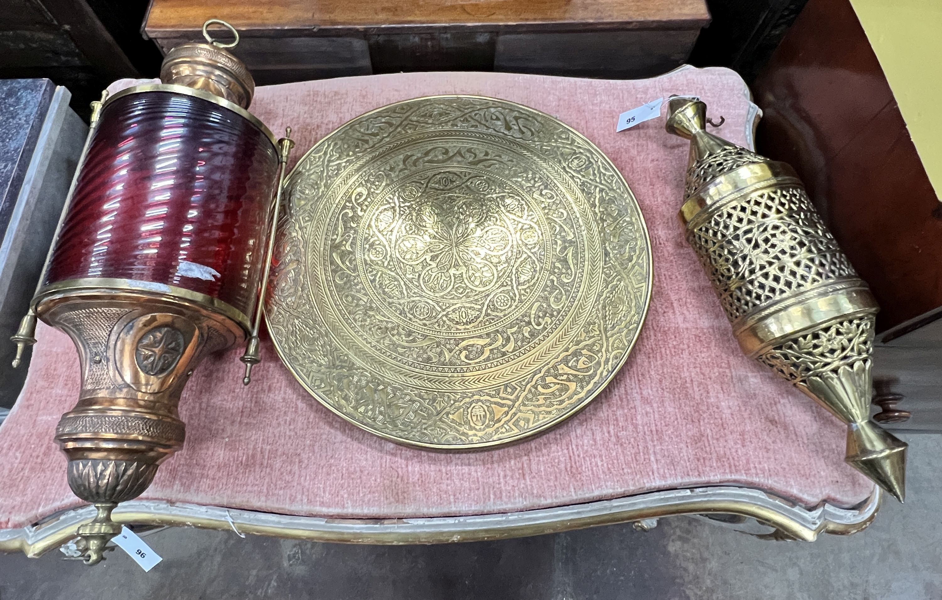 A copper and ruby glass lantern, height 70cm, a Moorish brass lantern, height 52cm and a Benares brass table top